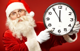 Santa looking at a clock that says 11:55