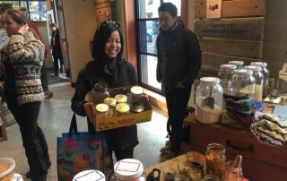 Zero Waste Market woman smiling with box of bulk food