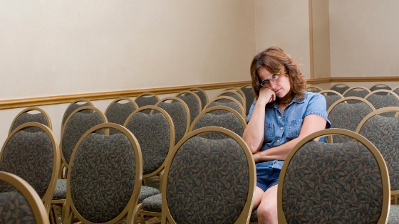 Woman slouching bored in a hotel meeting room