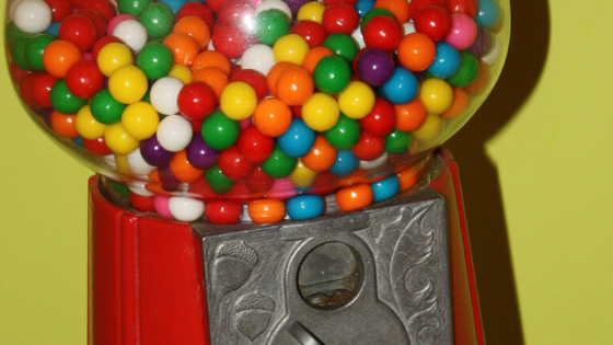 photo of a vintage globe gumball machine with multicolored gumballs