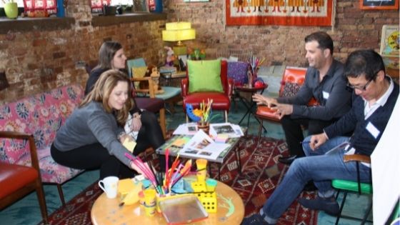 A group of coworkers in discussion at a business retreat at Catalyst Ranch