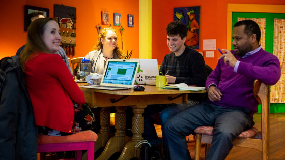a group of four coworkers seated at a Catalyst Ranch cafe table in the Jitterbug Room